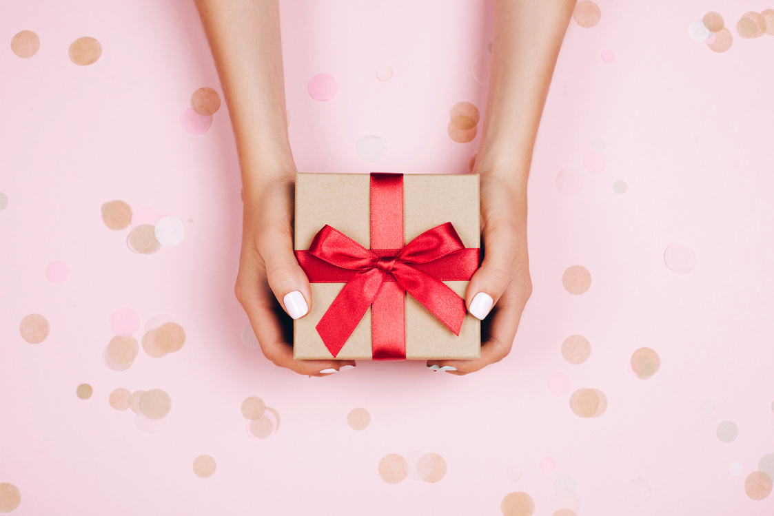 Hands holding present box